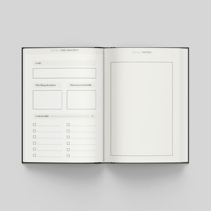 Productivity planner opened to goal planning pages featuring a structured goal framework, progress checklist and notes page for planning.