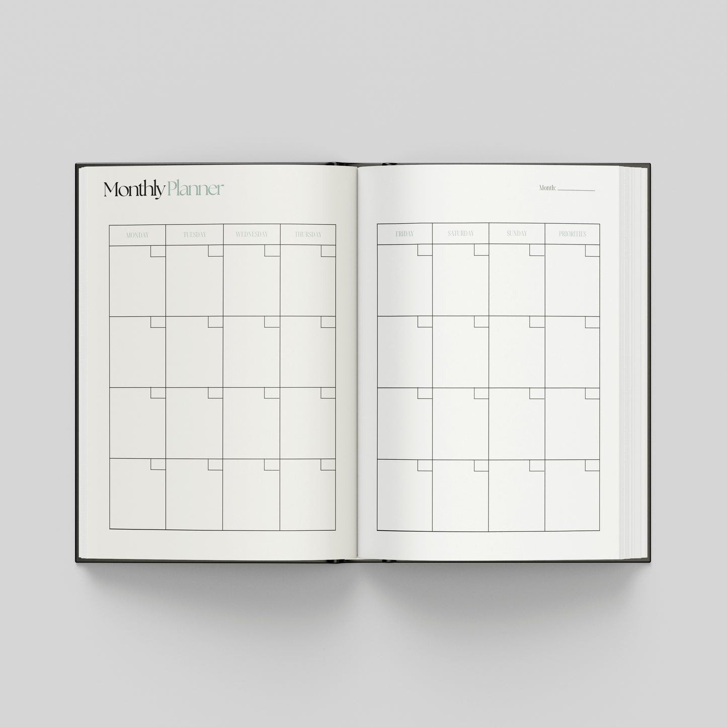 Open productivity planner showing a monthly planning calendar with weekday headings and spacious boxes for organising appointments and goals.
