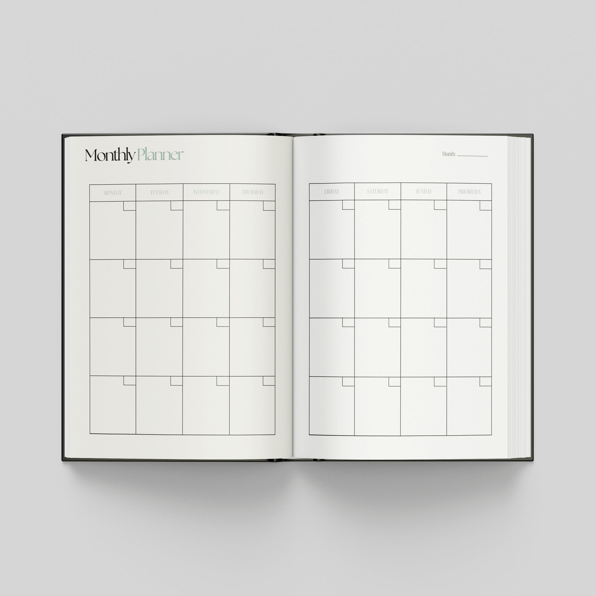 Open productivity planner showing a monthly planning calendar with weekday headings and spacious boxes for organising appointments and goals.