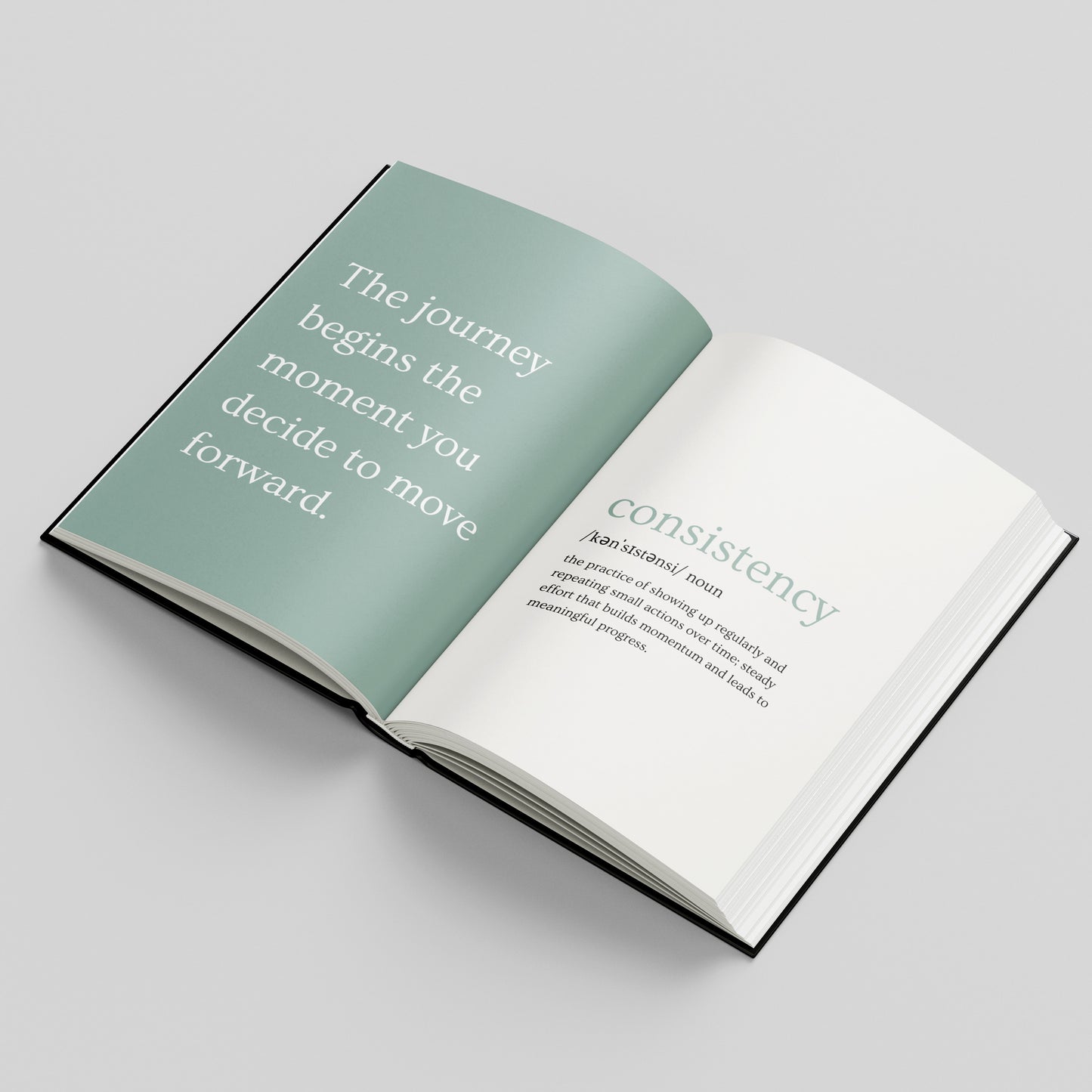 An open hardcover book on a light grey background, showing a blue left page with the quote 'The journey begins the moment you decide to move forward.' and a white right page with the word 'consistency' and a definition.