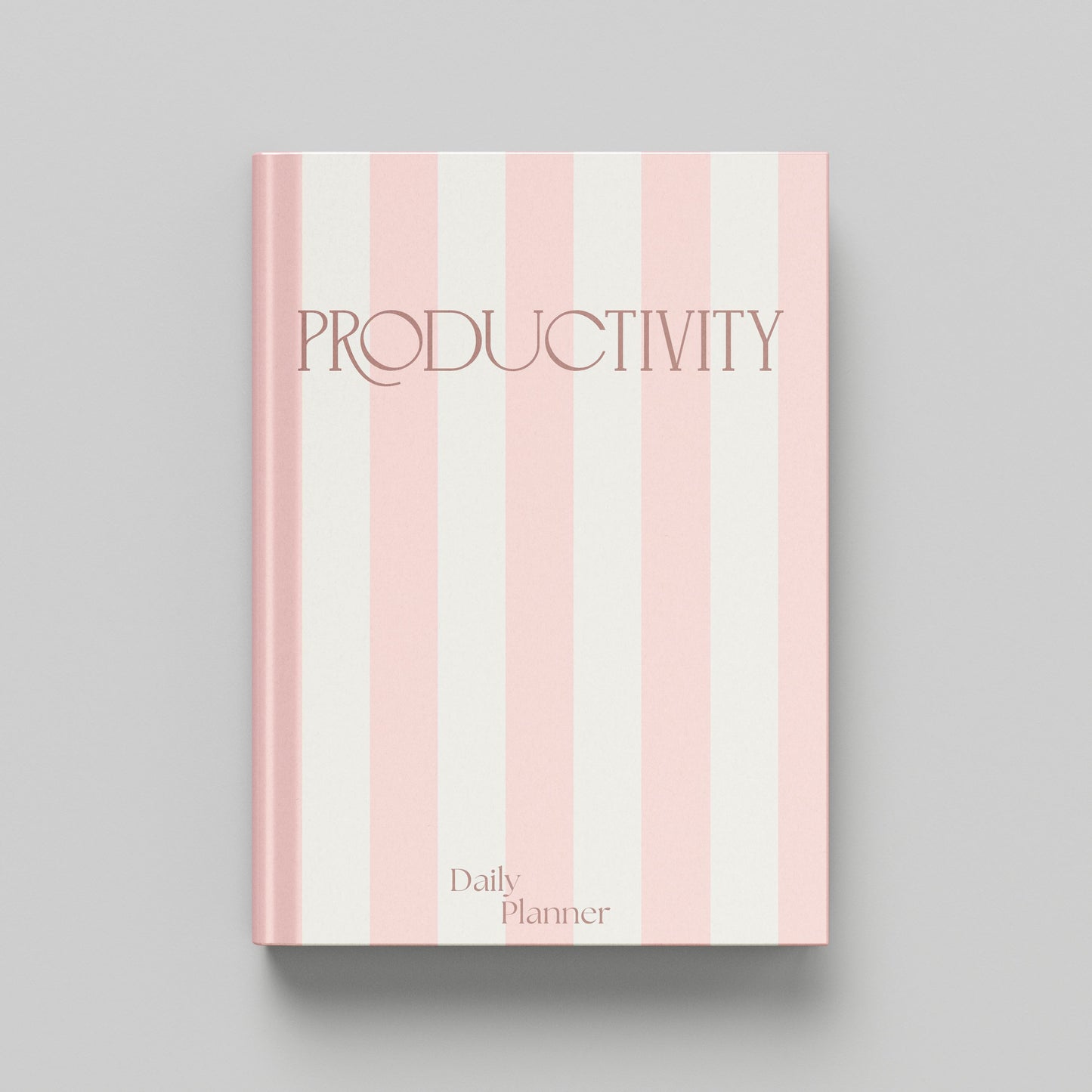 A hardcover daily planner with a pink and off-white vertical striped cover, featuring the word 'PRODUCTIVITY' in a dark pink serif font and 'Daily Planner' at the bottom, shown on a neutral grey background.