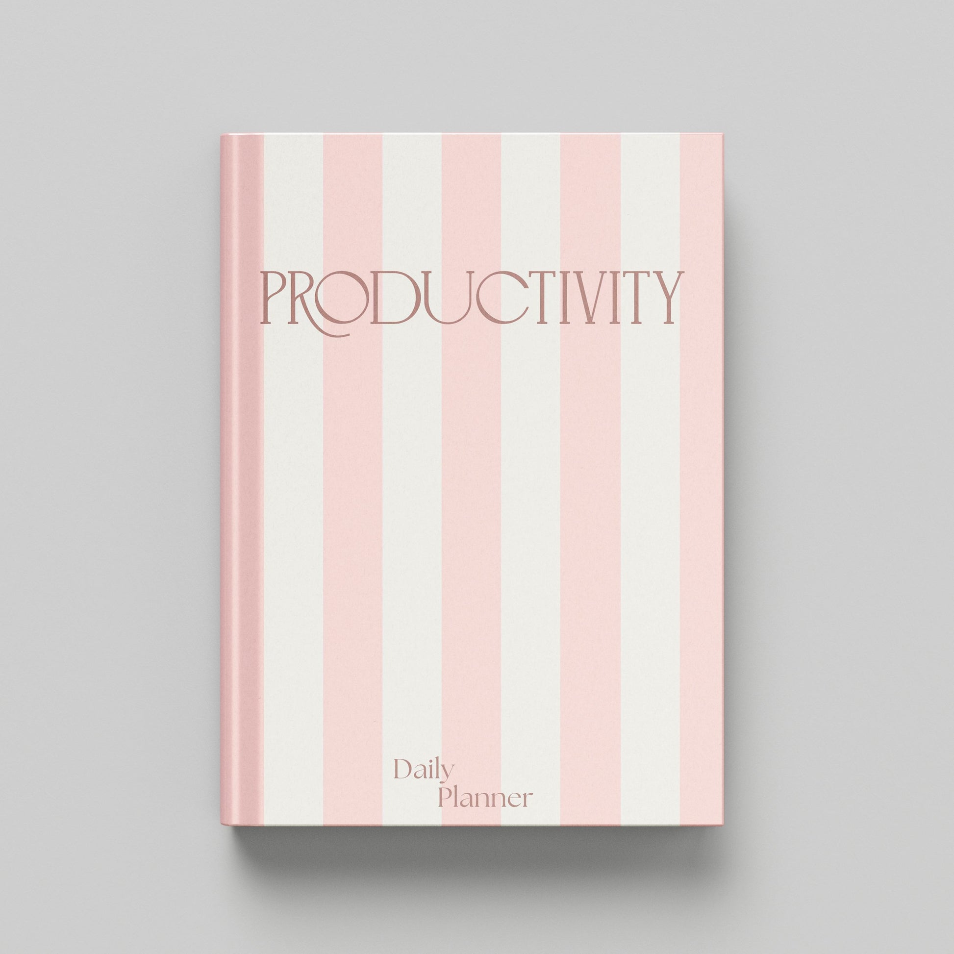 A hardcover daily planner with a pink and off-white vertical striped cover, featuring the word 'PRODUCTIVITY' in a dark pink serif font and 'Daily Planner' at the bottom, shown on a neutral grey background.