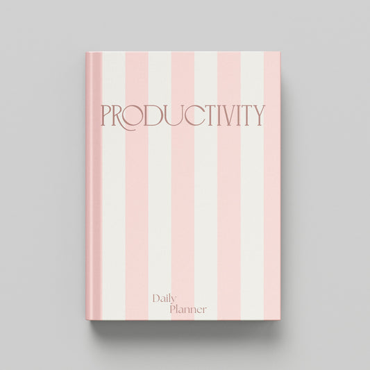 A hardcover daily planner with a pink and off-white vertical striped cover, featuring the word 'PRODUCTIVITY' in a dark pink serif font and 'Daily Planner' at the bottom, shown on a neutral grey background.
