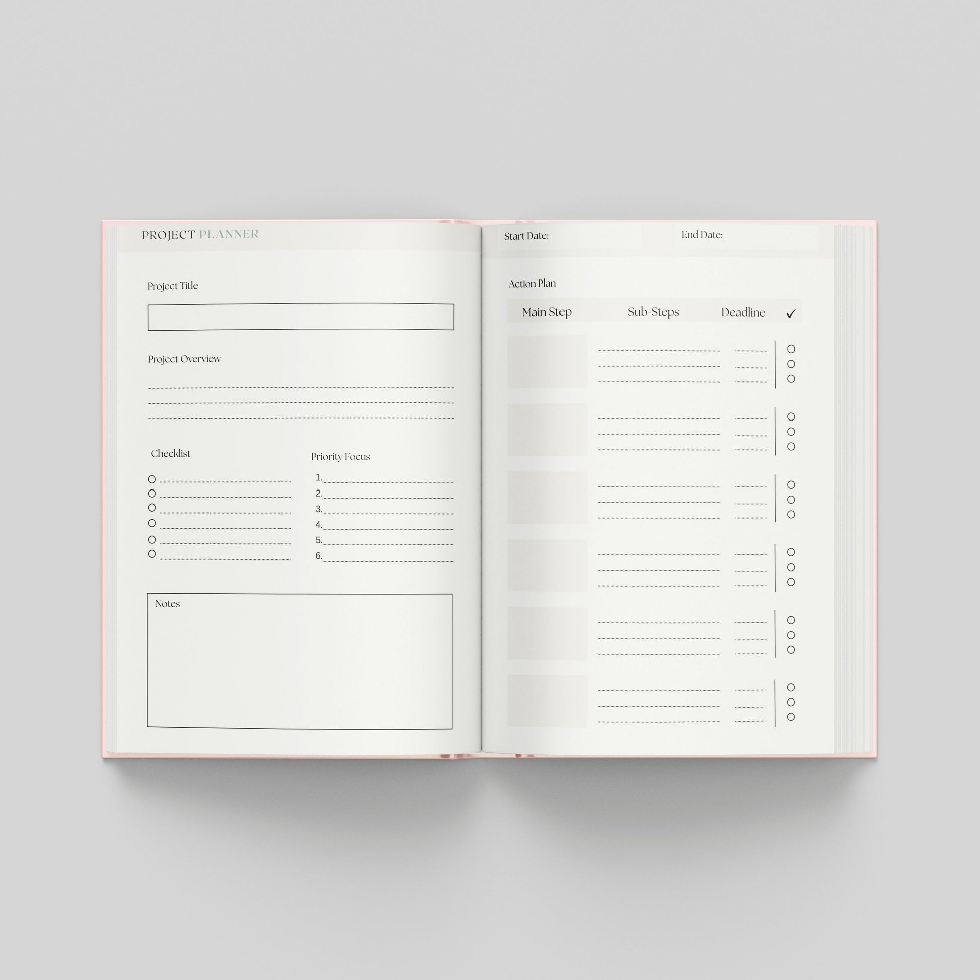 An open planner showing two interior pages for a project planner, photographed from above on a light grey background. The pages are white with thin black lines and text, and the planner edges are pale pink.